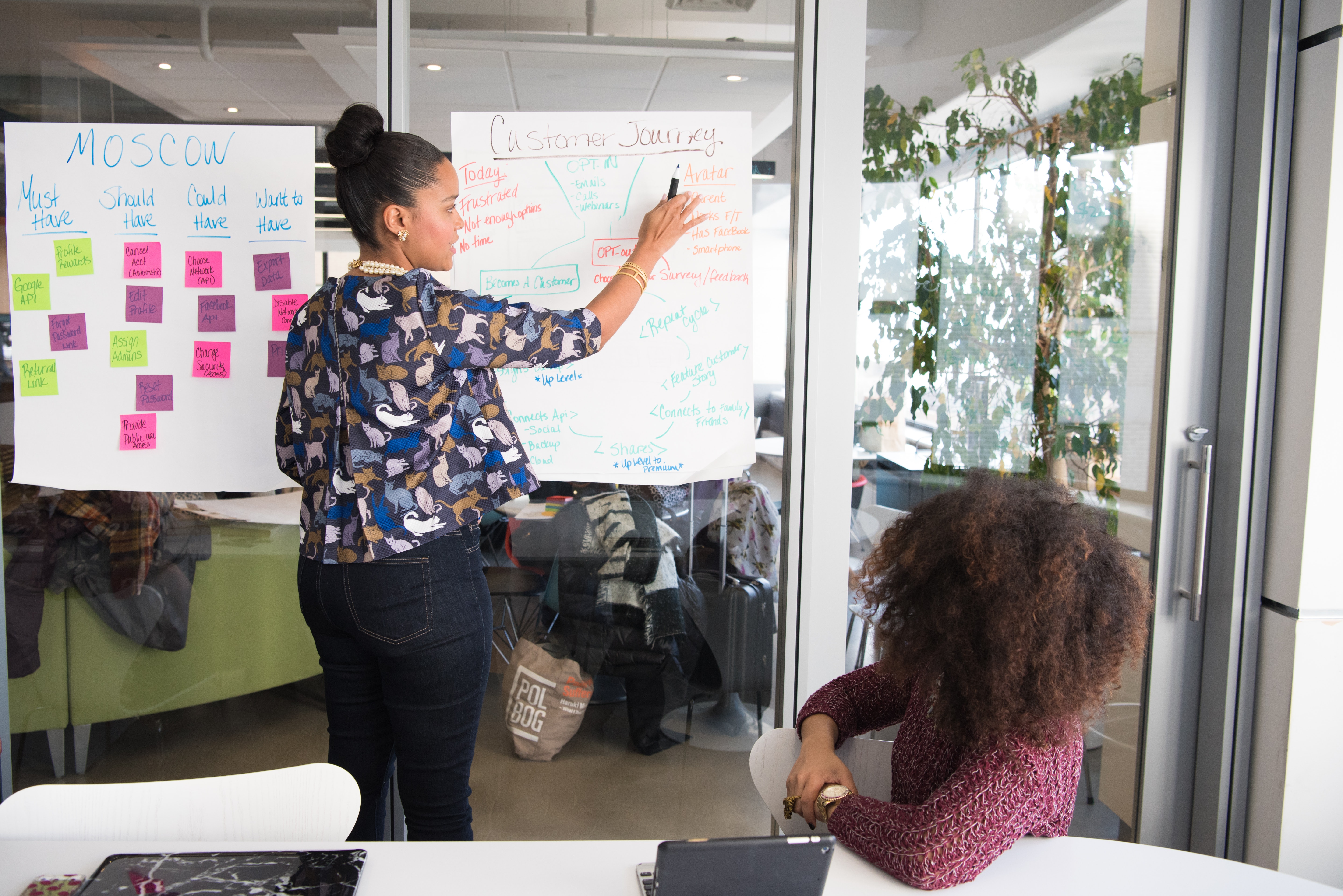 two-women-having-a-meeting-inside-glass-panel-office-1181615